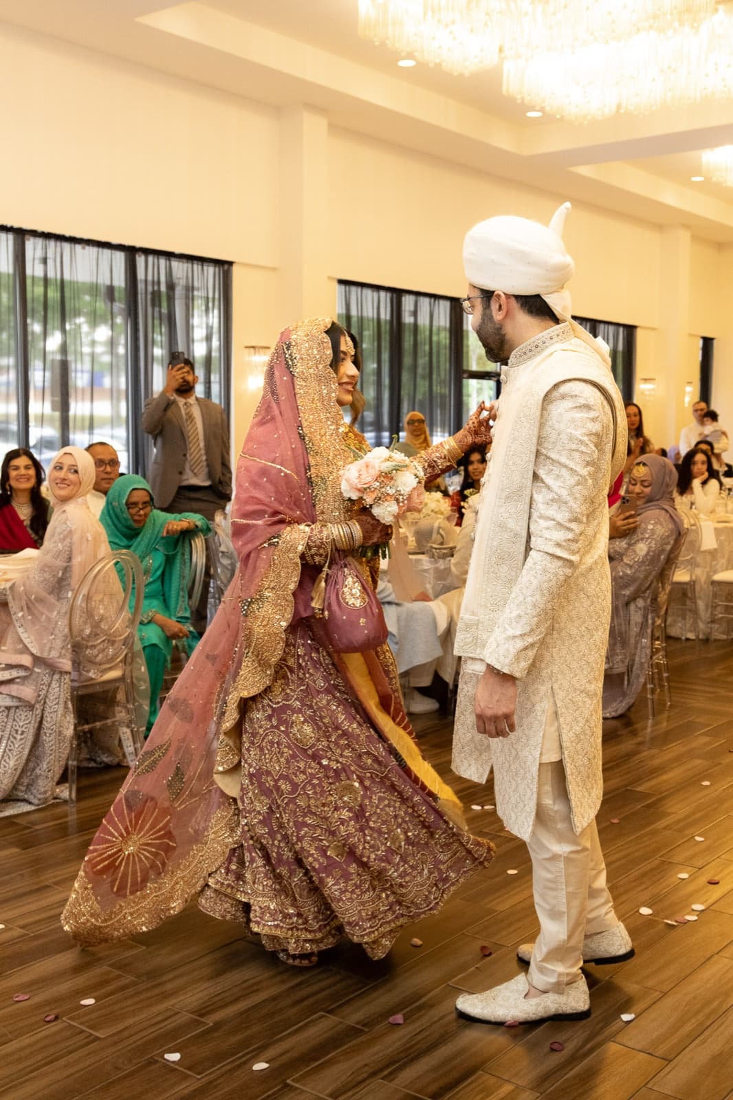 The first dance-in: Ayesha in her rose and gold lehenga meeting Faisal on the ballroom floor