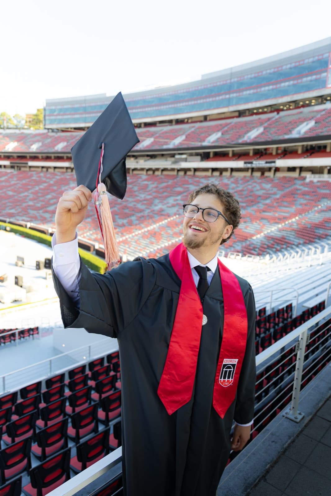 Holding the cap up to ninety thousand empty seats