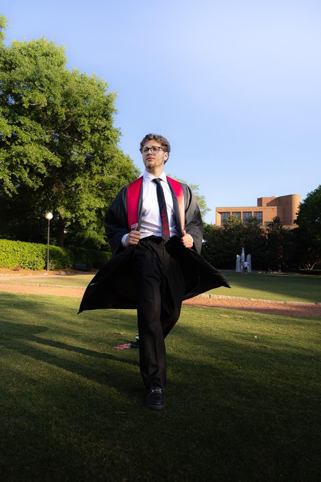 Mid-stride across the North Campus lawn, gown flowing